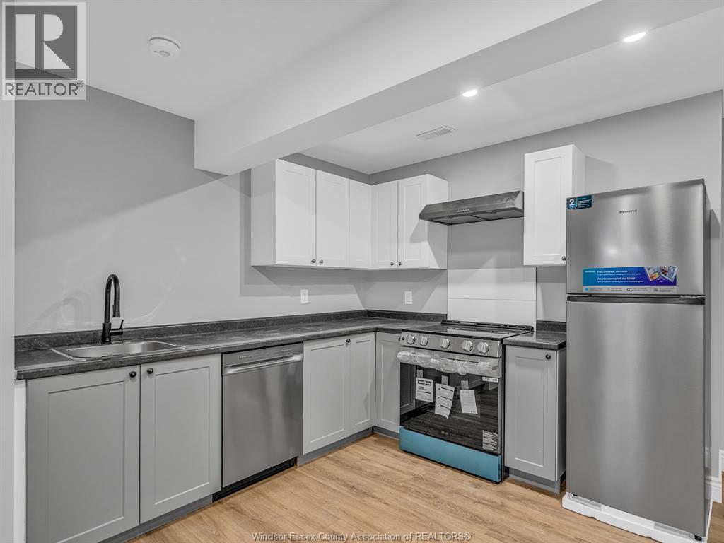 A kitchen with a stainless steel refrigerator and a dishwasher.