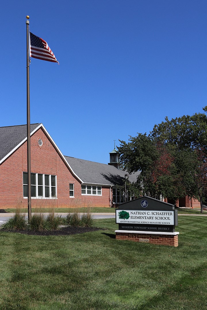 an flag flying in front of a school building