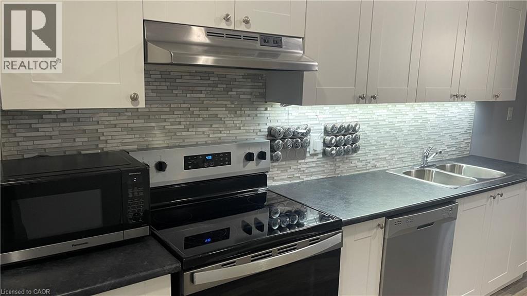 A modern kitchen with a stove top oven and microwave.