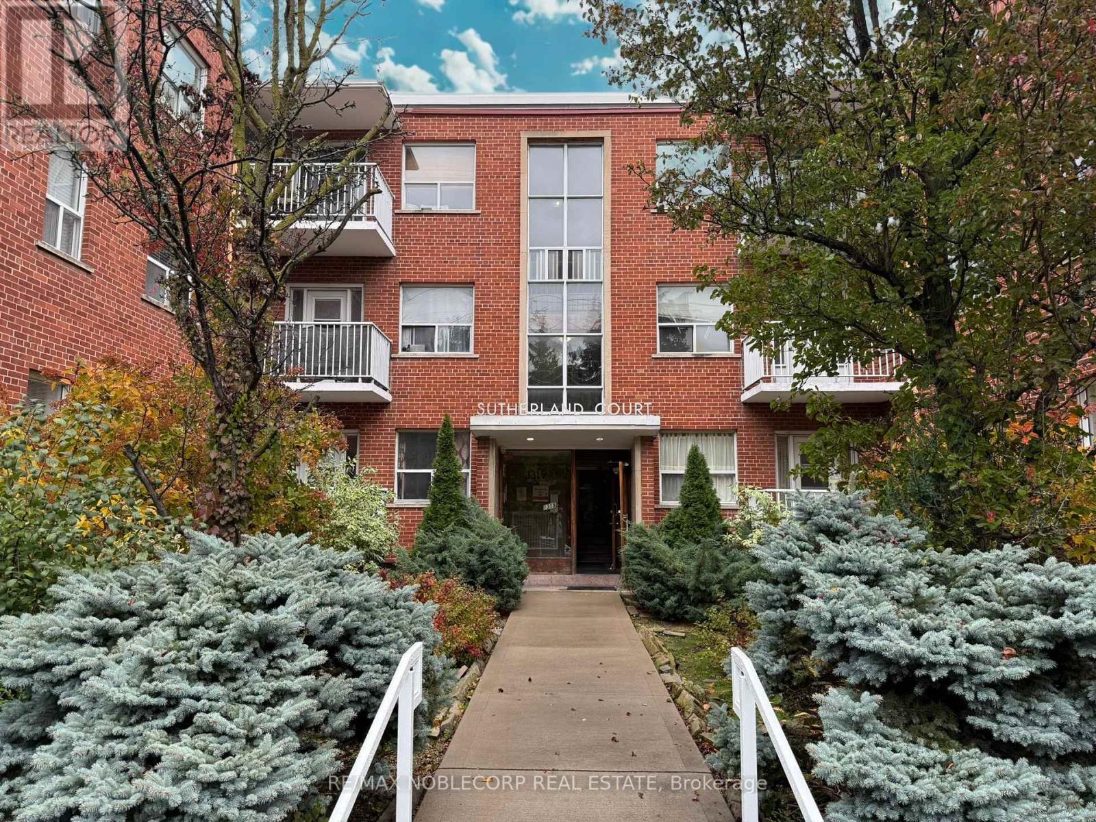 A brick building with the words "Sunrise Land Court" on the front.