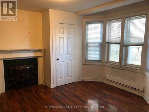 A room with a fireplace and a door.