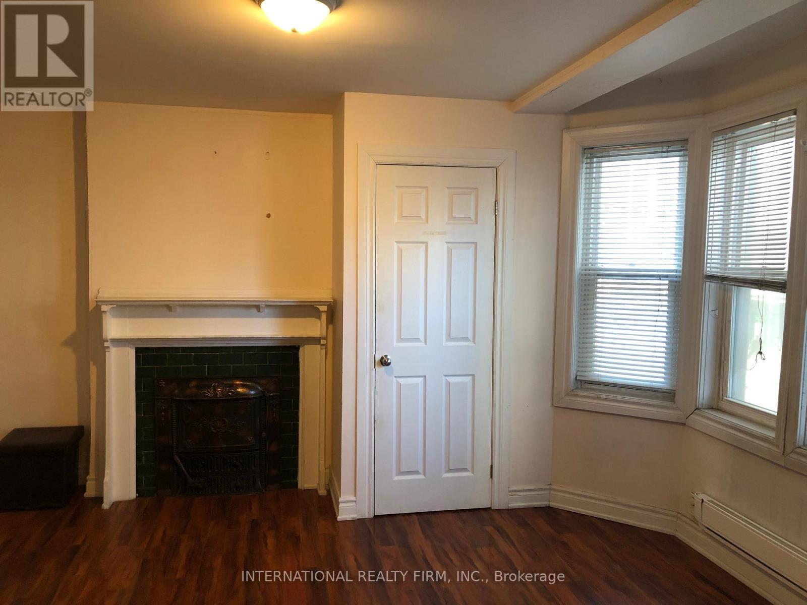 A room with a fireplace and a door.