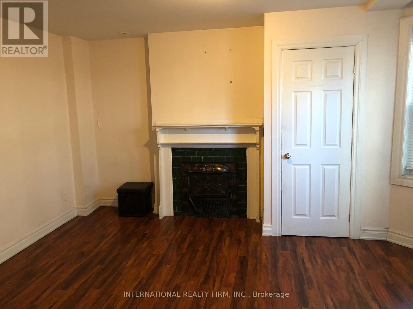 A room with a fireplace and a door.