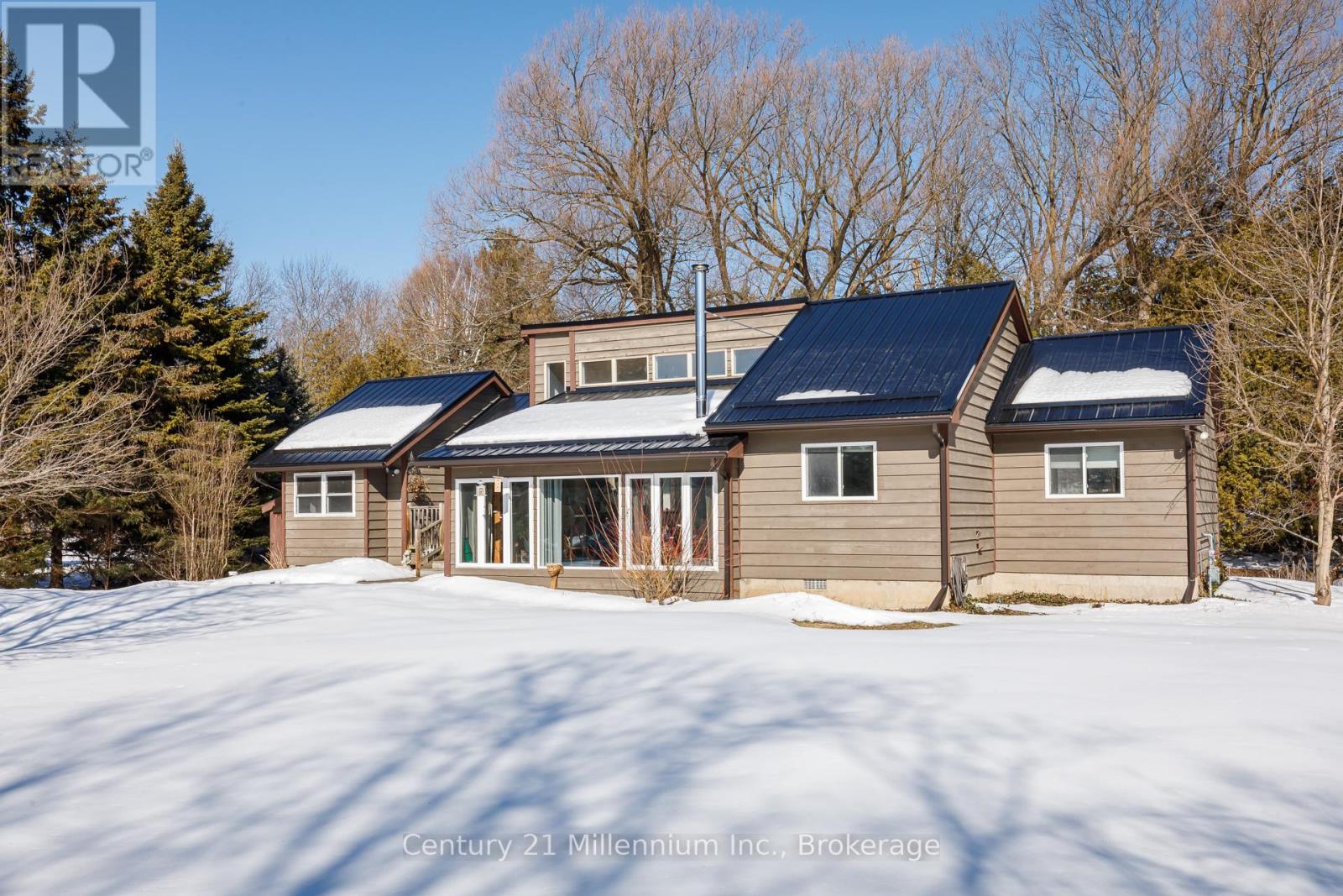 A house with a snowy ground in front of it.
