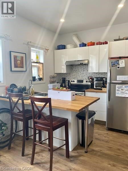 A kitchen with a wooden table and chairs.