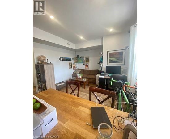 A living room with a couch, a coffee table, and a bicycle.