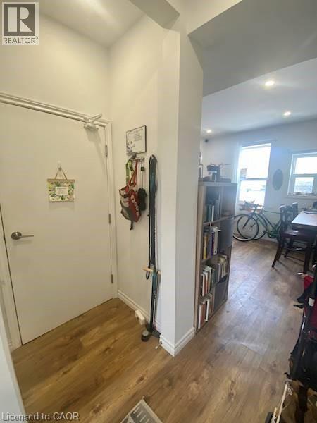 A hallway with a door and a wall with a clock on it.