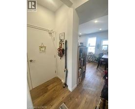A hallway with a door and a wall with a clock on it.