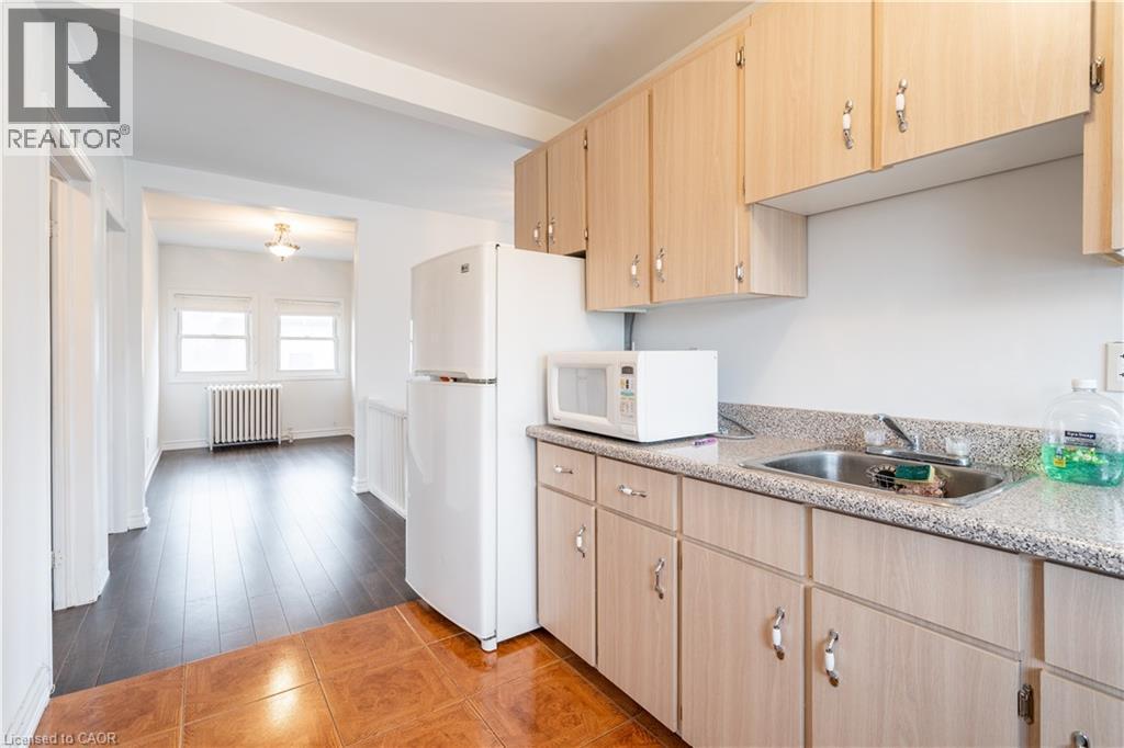 A kitchen with wooden cabinets and a white refrigerator.
