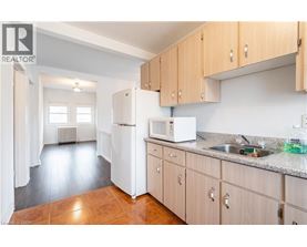 A kitchen with wooden cabinets and a white refrigerator.