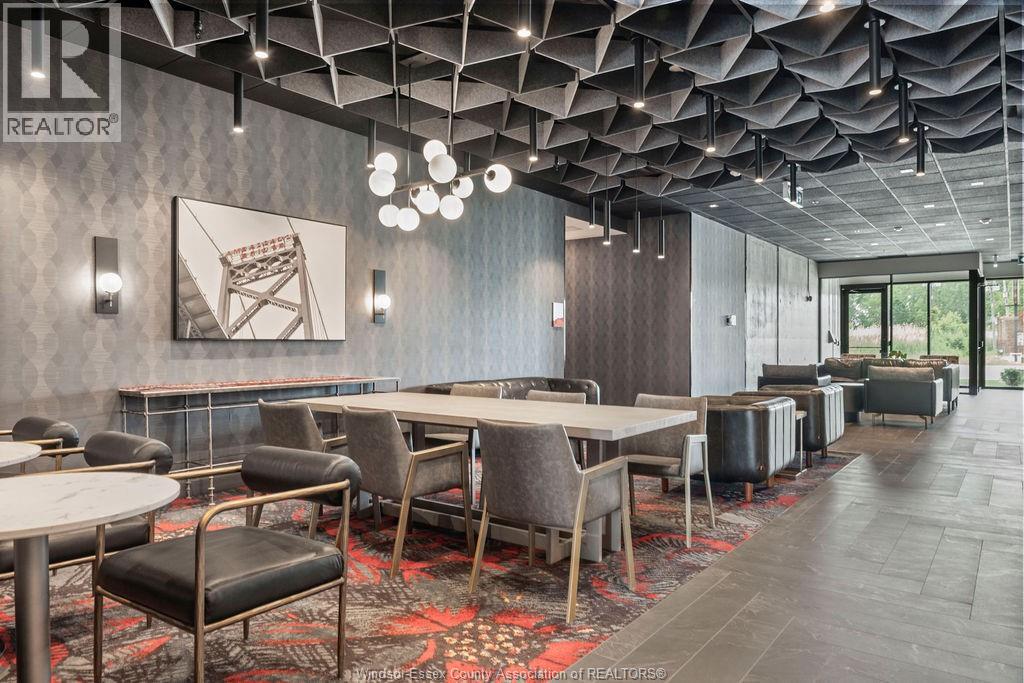 A modern dining room with a long table and chairs.