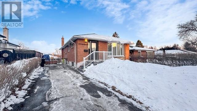 A house with a snow-covered pathway leading to the front door.