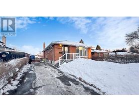 A house with a snow-covered pathway leading to the front door.