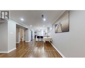 A spacious room with a dining table set up in the middle.