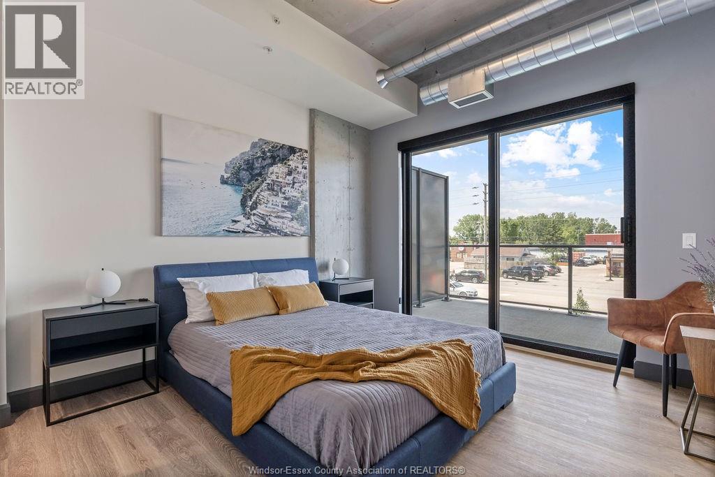 A bedroom with a large bed and a view of the outside.