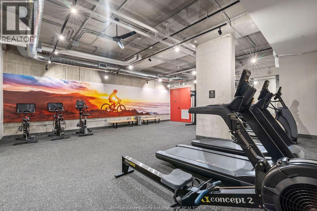 A gym with a row of exercise bikes and a row of treadmills.