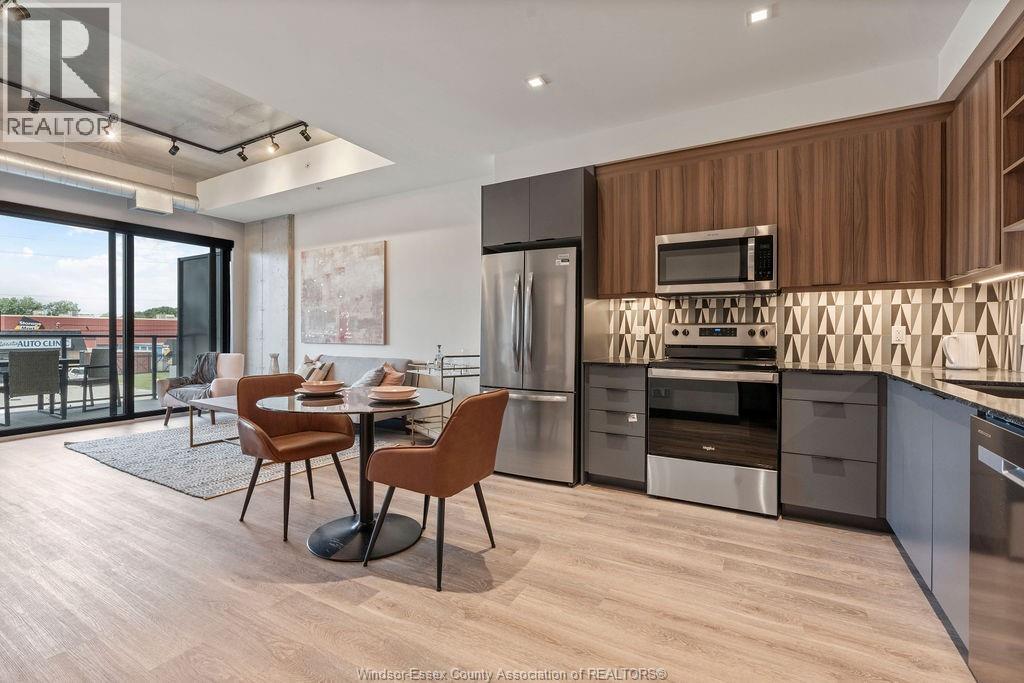 A modern kitchen with a dining table and chairs.