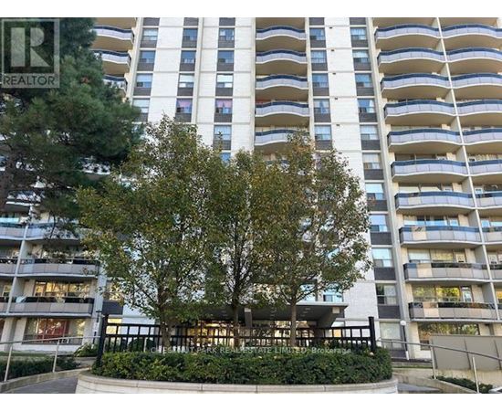 A tall residential building with a tree in front.