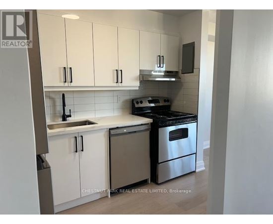 A kitchen with white cabinets and stainless steel appliances.