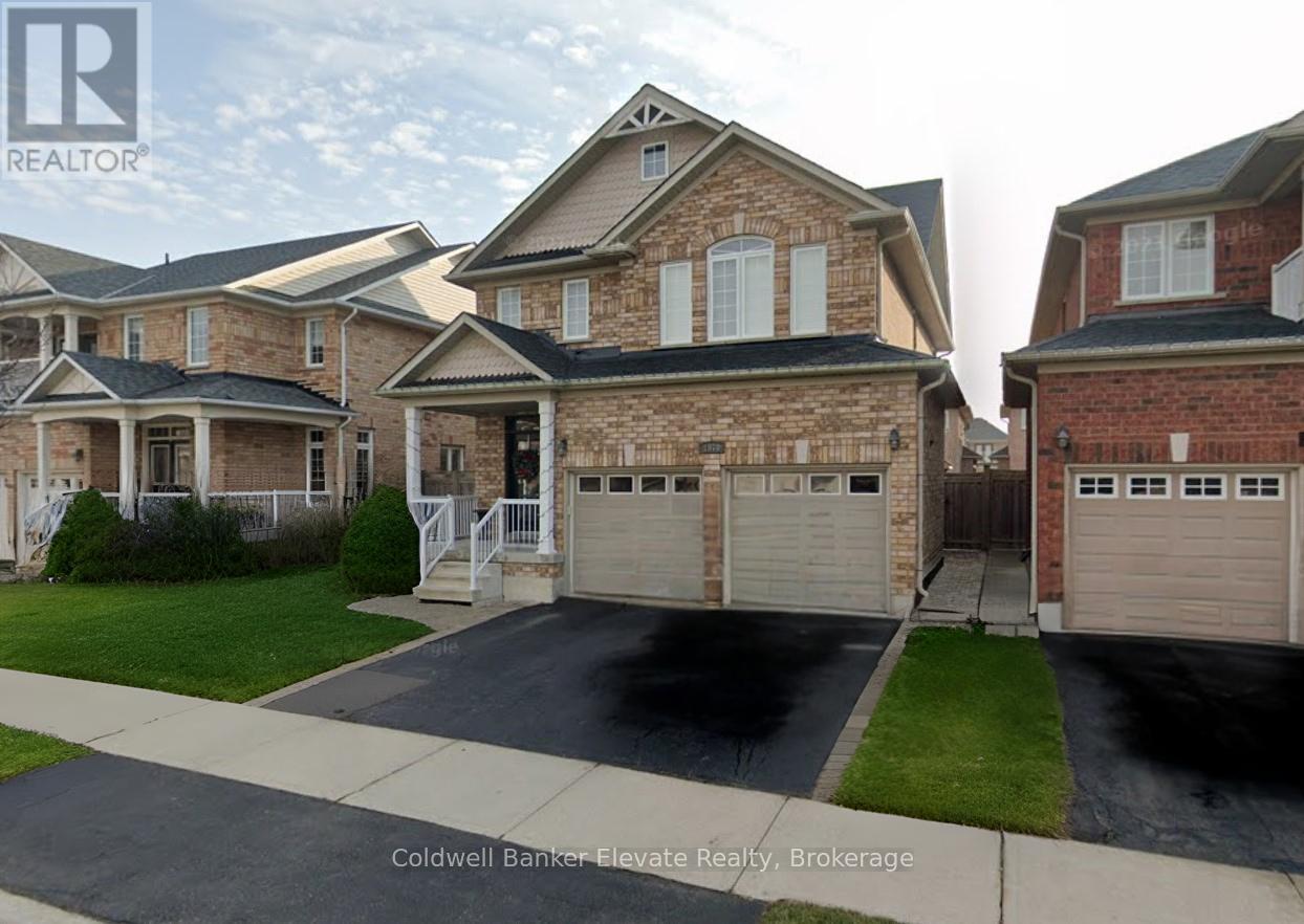 A real estate photo of a house with a driveway in front.