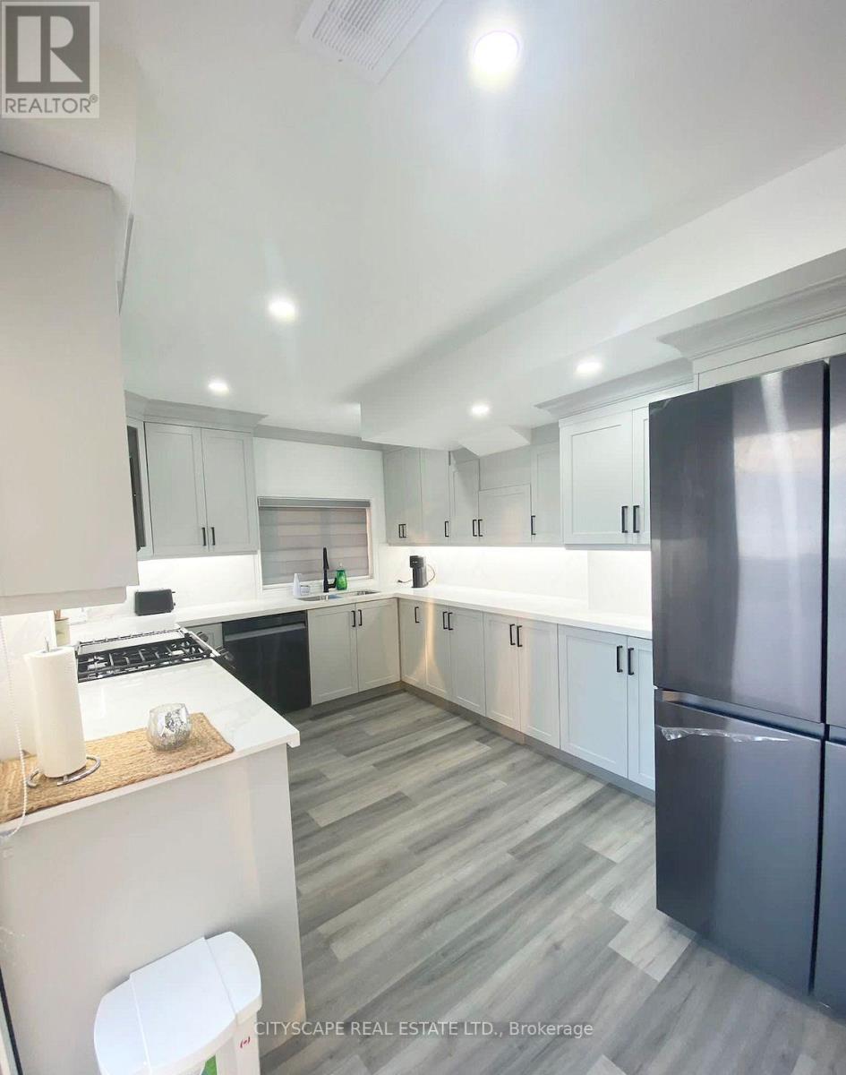 A modern kitchen with a refrigerator on the right and a countertop with a white candle on it.