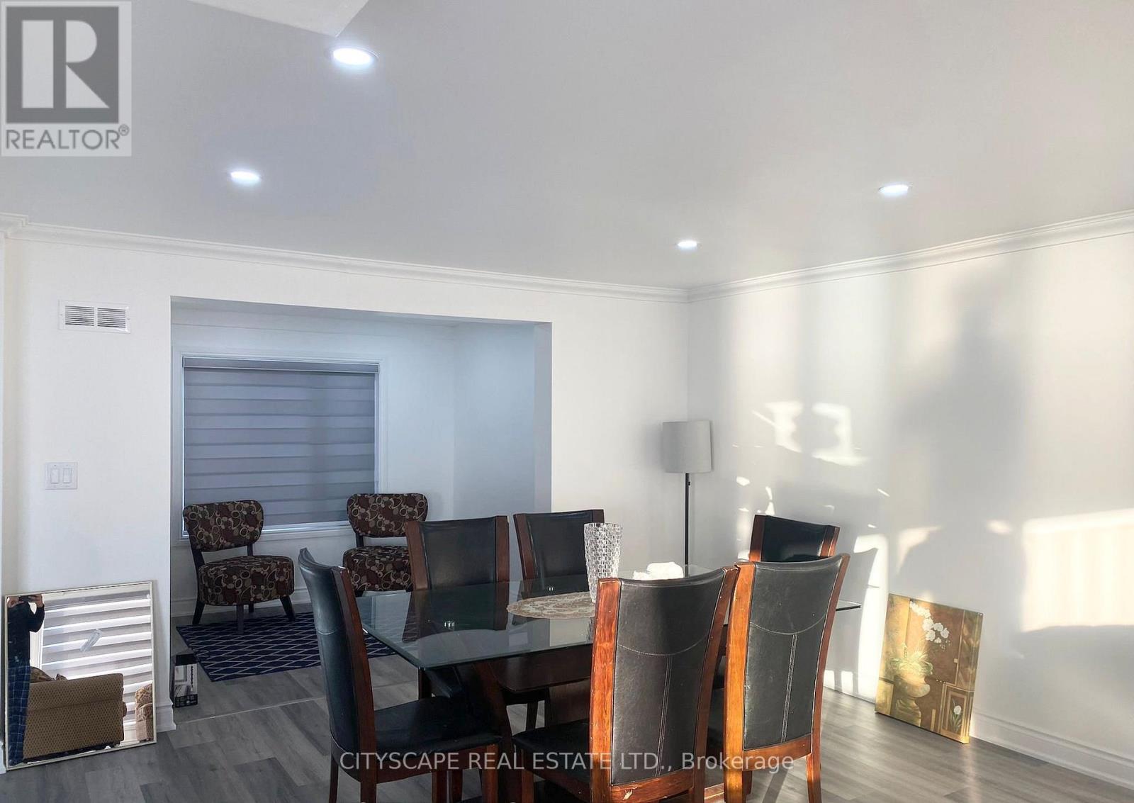 A dining room with a glass table and chairs.