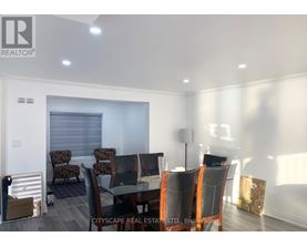 A dining room with a glass table and chairs.