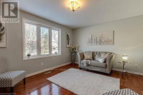 A living room with a couch, chair, and a rug.