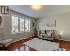 A living room with a couch, chair, and a rug.
