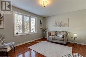 A living room with a couch, chair, and a rug.