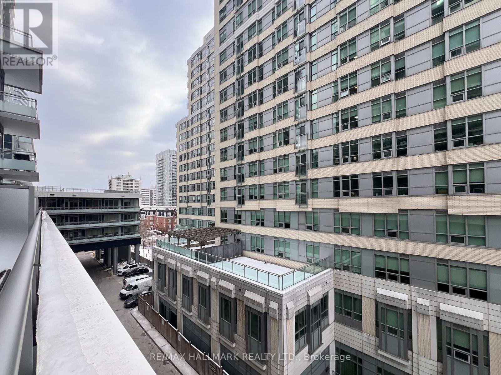 A view of a cityscape with a large building in the foreground and other buildings in the background.