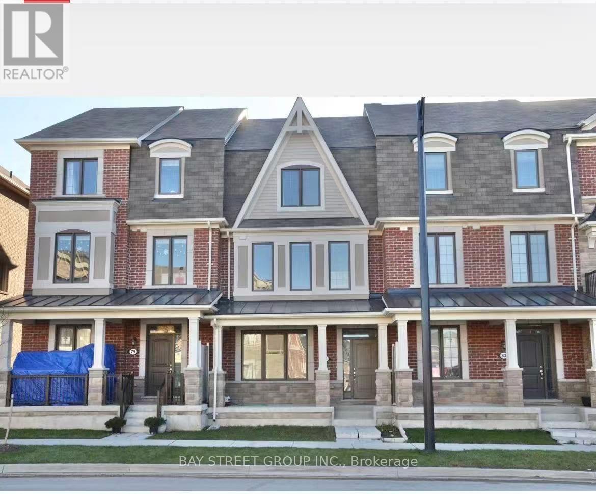 A large, multi-story residential building with a brick facade and multiple windows.