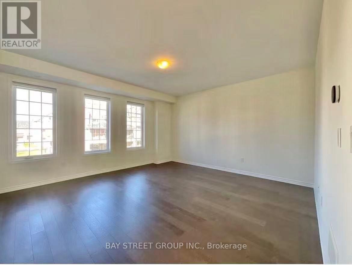Empty room with wooden floors and white walls.
