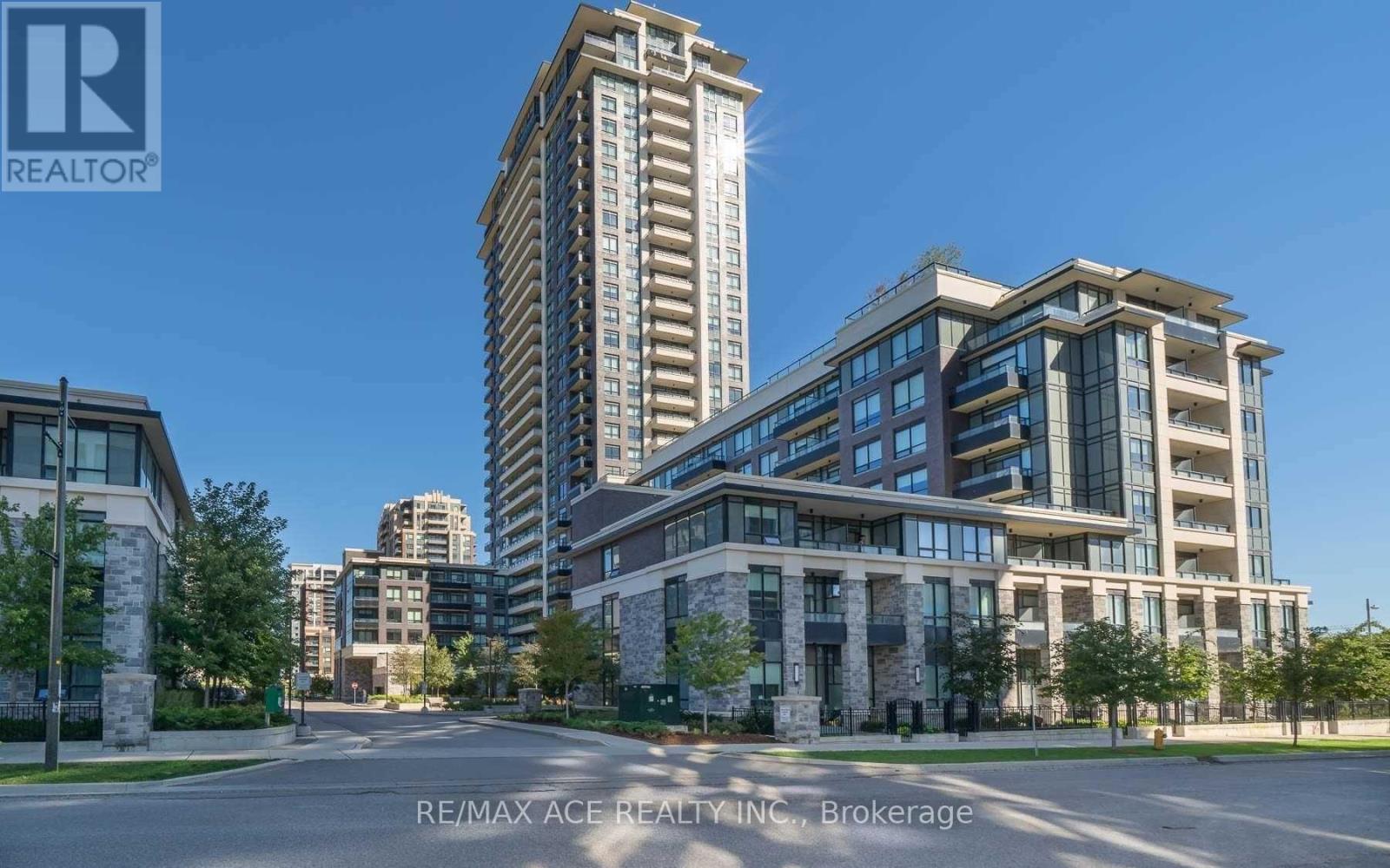 A modern apartment complex with a tall building in the background.