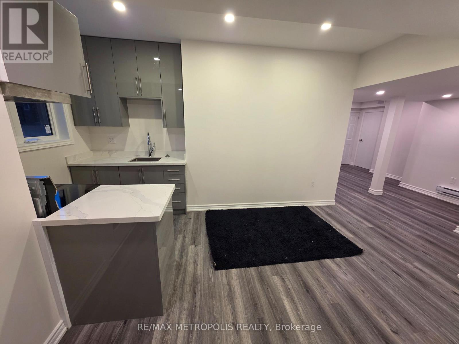 A kitchen area with a sink and a counter.