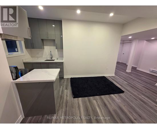 A kitchen area with a sink and a counter.