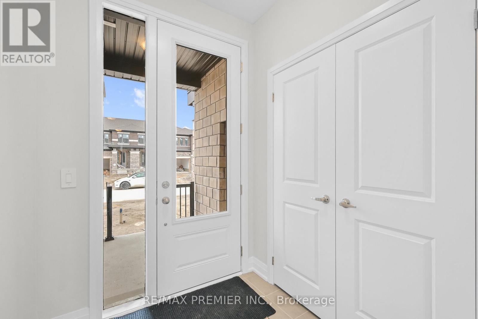 A white door with a glass window is open to a balcony.