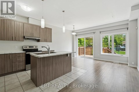 A kitchen with a sink, stove, and cabinets is shown in this image.
