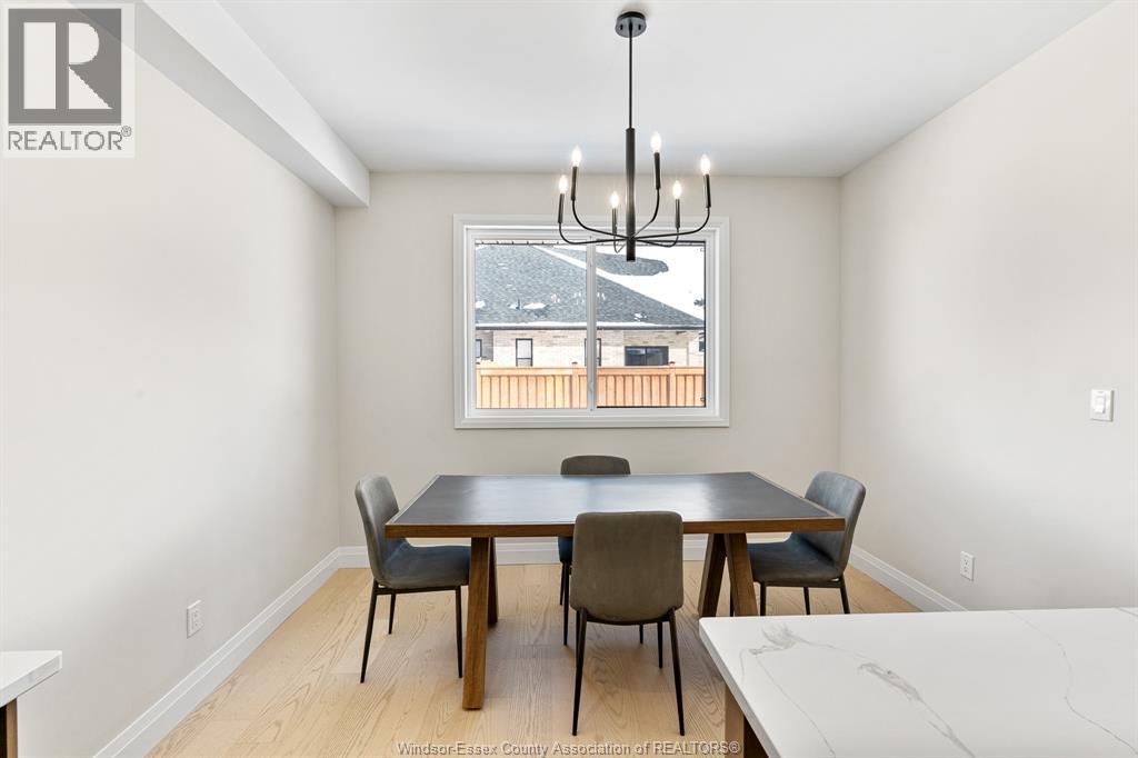 A dining room with a table and chairs.
