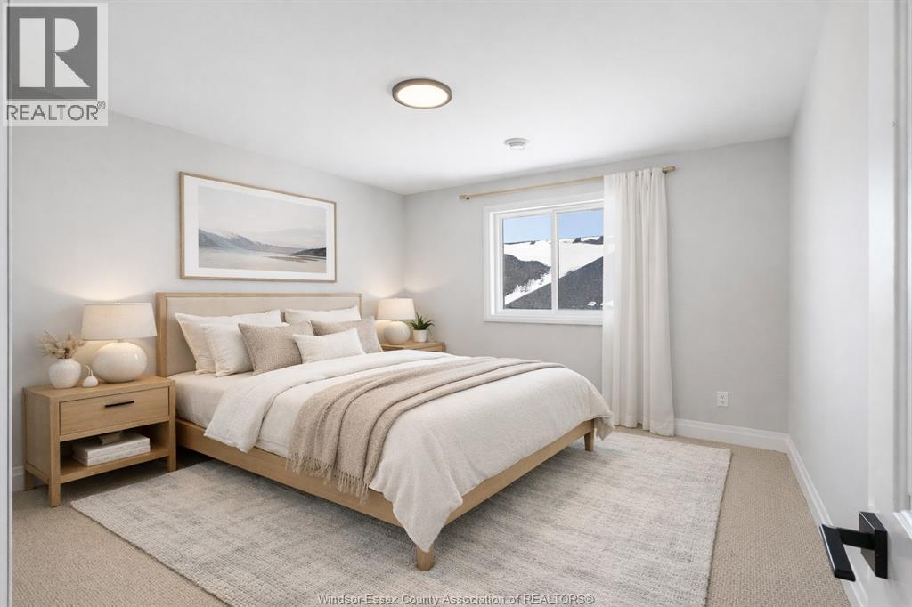 A bedroom with a large bed and a painting on the wall.