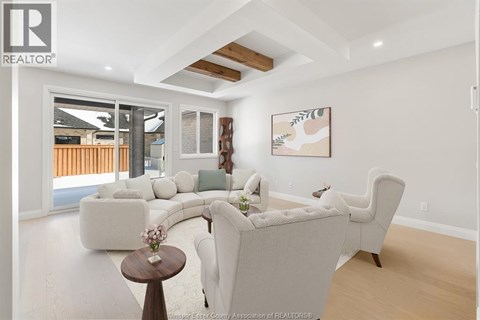A living room with a white couch and a wooden table.