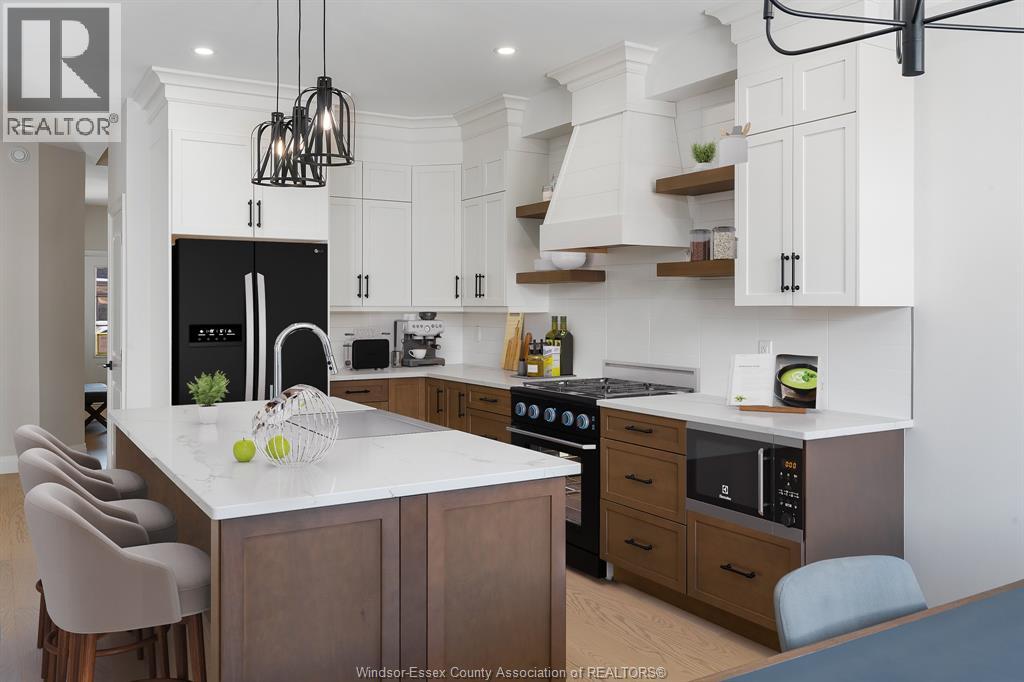A kitchen with a black fridge and a white counter top.