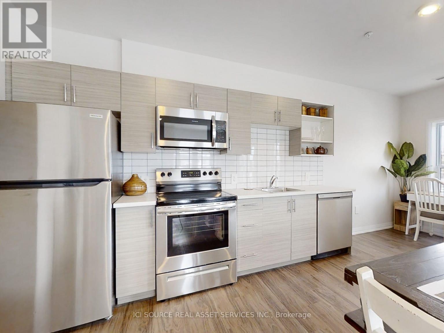 A modern kitchen with a stainless steel oven and microwave above the stove.