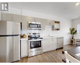 A modern kitchen with a stainless steel oven and microwave above the stove.