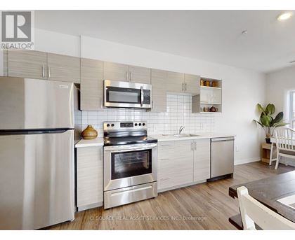 A modern kitchen with a stainless steel oven and microwave above the stove.