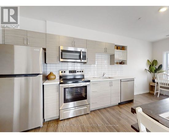 A modern kitchen with a stainless steel oven and microwave above the stove.
