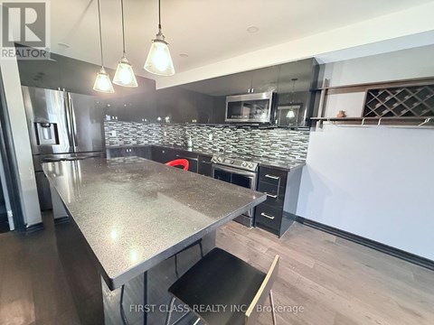 A modern kitchen with a large island in the center.