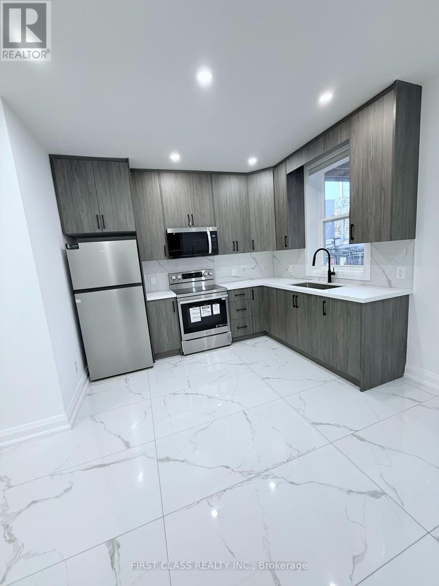 A modern kitchen with a marble floor and stainless steel appliances.