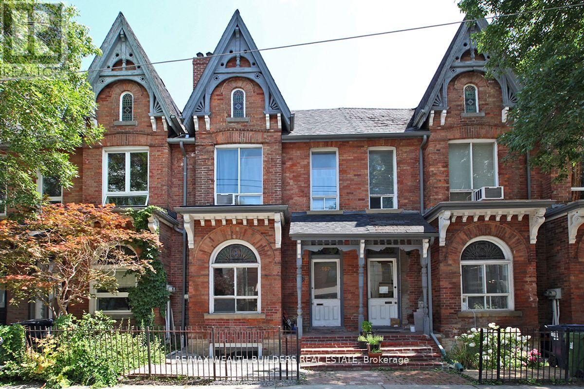 A large red brick house with a grey front door.