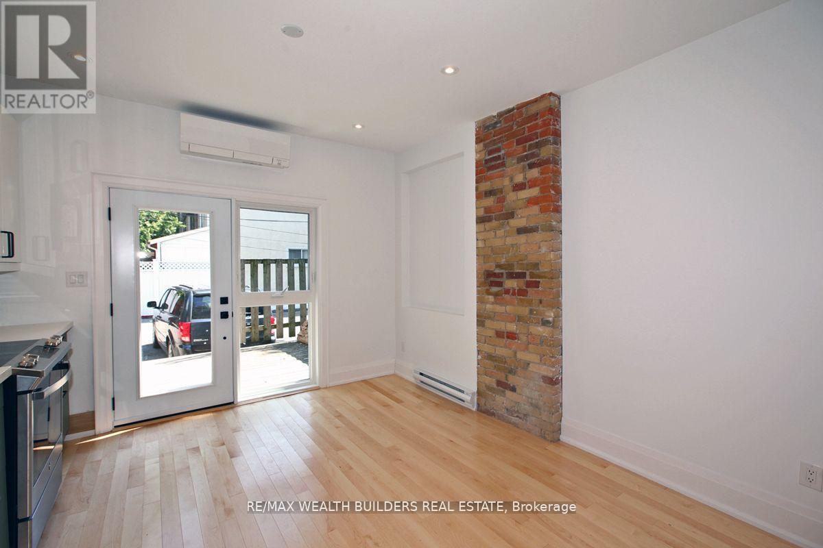 A room with a brick column and a sliding glass door.